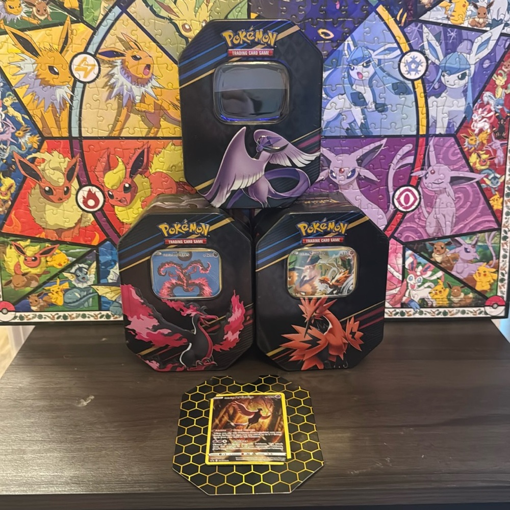 Pokémon Tins 3 with cards shown, empty